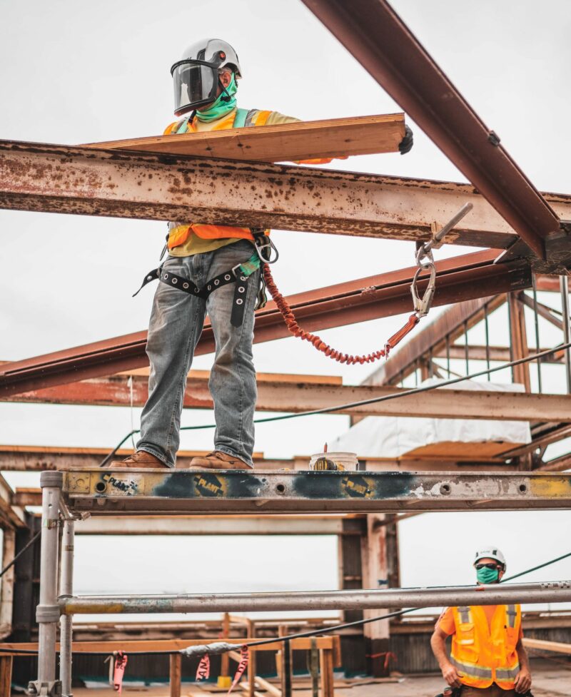 iron working welding joints on building construction worker building frame